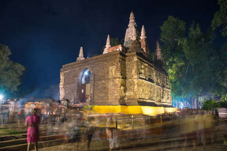 CHIANG MAI THAILAND  JUN 01: Clergy and Buddhists candle lit around mock bodh gaya pagoda in Vesak Day at Jed Yod temple on June 01 2015 in Chiang Mai Thailand.のeditorial素材