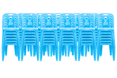 Stack of blue plastic chairs on whiteの写真素材