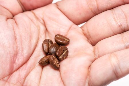 Closeup coffee beans on hand.の写真素材