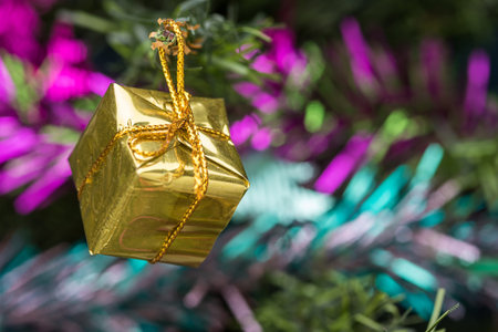 Golden gift box decorations on christmas tree, Select the focus.の写真素材