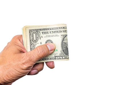 Cash US dollars on hand, isolated on white.