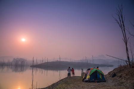 Beautiful sunrise over a lake with mist faded,Thailand.の写真素材