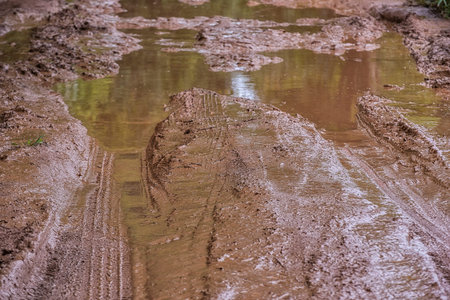 Tire tracks on a muddy road in the rural, Routing traffic at countryside.の写真素材