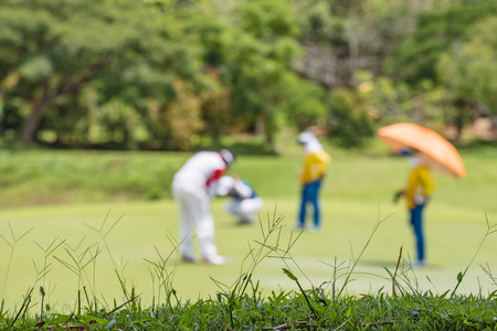 Defocus or blurred man figure playing golf on golf course, used for background.の写真素材