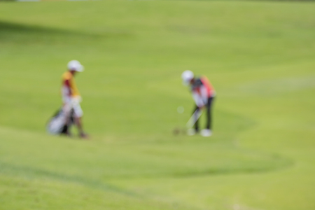 Defocus or blurred man figure playing golf on golf course, used for background.の写真素材