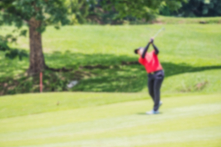 Defocus or blurred man figure playing golf on golf course, used for background.の写真素材