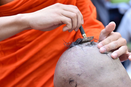 Buddhist monks hair shave young men to be ordained a new monk.の写真素材