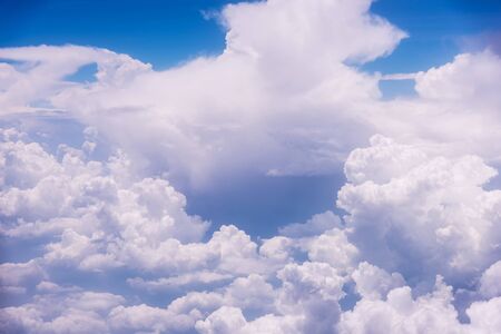 White clouds against blue sky view through an airplane window for a background.の写真素材