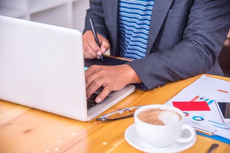 Businessman working on the laptop at her modern office.の写真素材