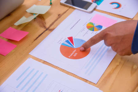 Business adviser analyzing financial figures denoting the progress in the work with team.の写真素材