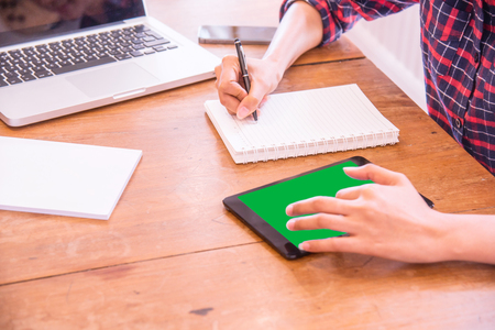 Businesswoman working on the tablet at her modern office.の写真素材
