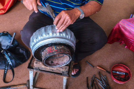 Hands of the craftsman hitting silverware a bas-relief with hammer.の写真素材