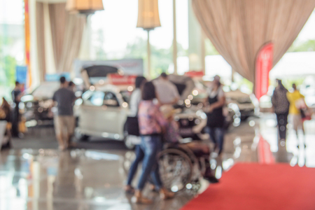 Blurred image of a people walking in motor show for background usage. Concept of business social gathering for meeting exchange.の写真素材