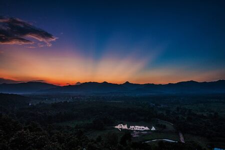 Sunset behind mountain in suburb Chiang mai, Thailand.の写真素材