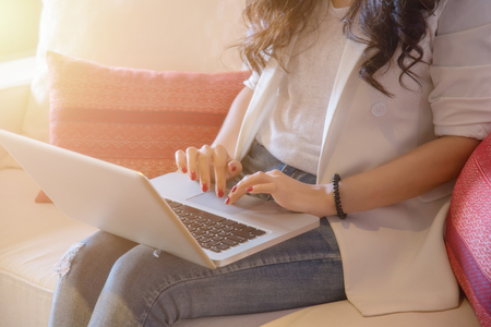 Young women working on laptop in a home, Home work space conceptの写真素材