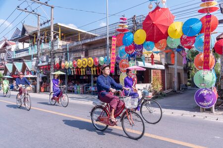 CHIANG MAI, THAILAND - JANUARY 18, 2019 : 36th anniversary Borsang umbrella festival, Unidentified peoples in traditional costume ride a bicycle during the annual Umbrella festival at San Kampaeng.のeditorial素材