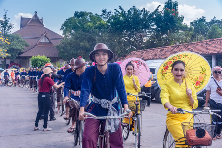 CHIANG MAI, THAILAND - JANUARY 18, 2019 : 36th anniversary Borsang umbrella festival, Unidentified peoples in traditional costume ride a bicycle during the annual Umbrella festival at San Kampaeng.のeditorial素材