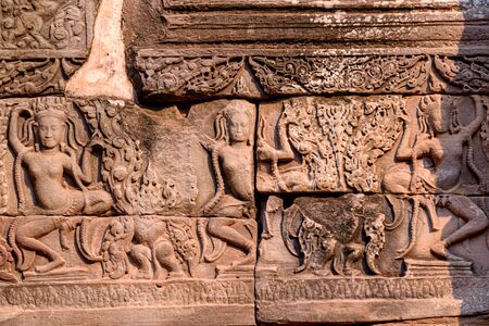 Stone carvings on the walls of the Bayon Temple in Angkor Thom, Siem Reap, Cambodia.の写真素材
