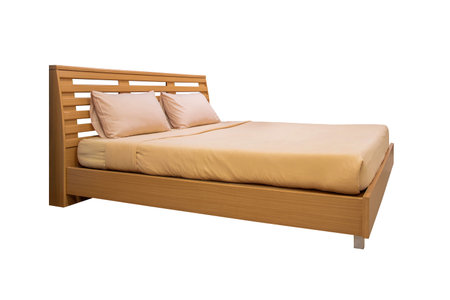 Wooden bed with light brown bedding isolated on white backgrounds work with clipping path.の写真素材