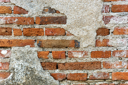 Old shabby wall cement cracks it is visible brickwork. Old Grungy Brickwork Texture.