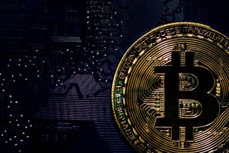 Bitcoin golden coins on a printed circuit board. Bitcoin concept, Blockchain technology,...