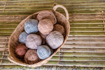 Cotton thread rolls in rattan basket preparing for cloth weaving. Material of traditional handmade...