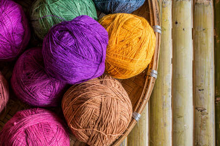 Cotton thread rolls in bamboo basket preparing for cloth weaving. Material of traditional handmade cloth weavingの写真素材