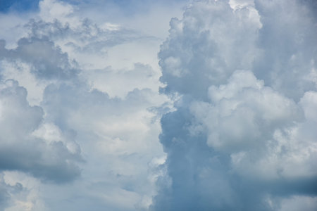 Beautiful cumulus clouds against the blue daytime sky. Cumulus is a fluffy cloud like a cotton ball.