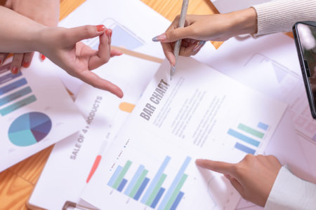 People's hands working with papers at meeting discussions shows successful teamwork. Asian business...