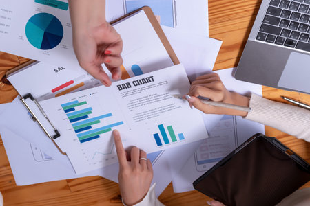 People's hands working with papers at meeting discussions shows successful teamwork. Asian business...