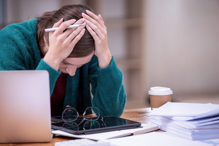 Businesswomen are stressed with work in front of a laptop and paper documents in the office....
