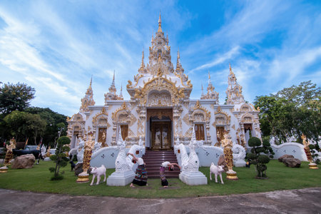 A Thai young girl dressed in traditional costumes visits a Sridonmoon temple in Chiang Mai, Thailand. Asian teenagers in traditional costumes at Thai Templeの写真素材