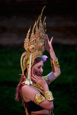 Portrait of a young Asian woman wearing an Apsara dress with ghost face makeup. Ancient ghosts in...