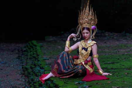 Portrait of a young Asian woman wearing an Apsara dress with ghost face makeup. Ancient ghosts in...