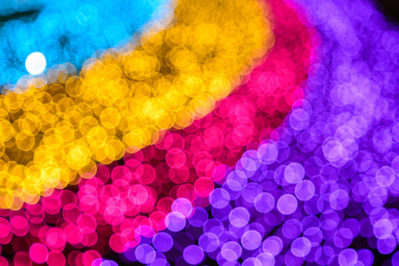 Colored decorative festive bokeh lights sparkle brightly. Abstract bokeh background.