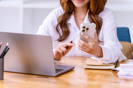 Hand of  young woman used smartphone in the office. Business casual concept.