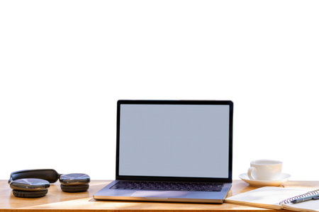 Mockup  laptop computer on wooden desk with coffee cup, headphones, notebook, and pen. with clipping...