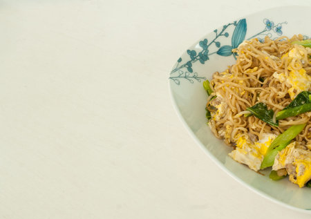 Fried Thai Mama Instant Noodles on white table.