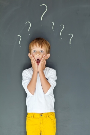 Child with many question marksの写真素材