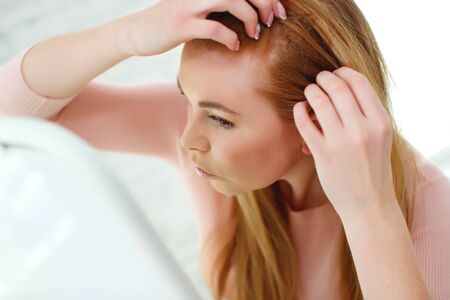 Hair problem. The woman has hair problems, to move.の写真素材
