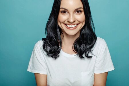 Beautiful woman. Studio portrait of a woman on a blue background.の写真素材
