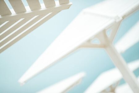Wooden umbrellas by the sea. Sun protection by the ocean.の写真素材