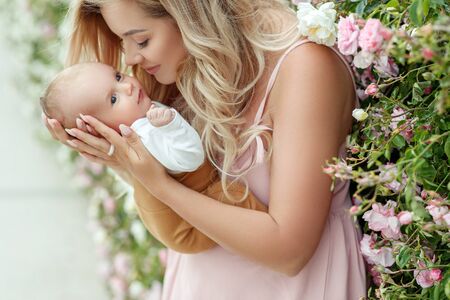 Beautiful woman with a baby in nature.の写真素材