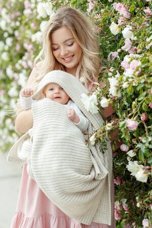 Beautiful woman with a baby in nature.の写真素材