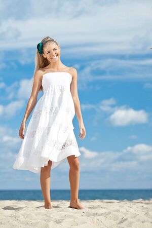 Girl by the sea with sand.の写真素材