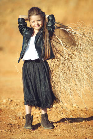 Childrens fashion. Fashionable child. Girl outdoors in fashionable clothes. High quality photo.の写真素材