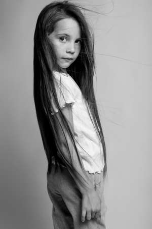 Beautiful child. Little girl in black and white studio. High quality photo.の写真素材