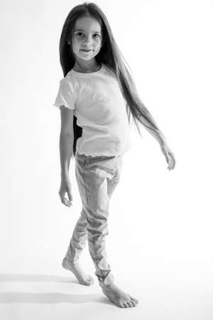 Beautiful child. Little girl in black and white studio. High quality photo.の写真素材