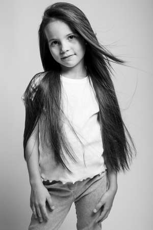 Beautiful child. Little girl in black and white studio. High quality photo.の写真素材