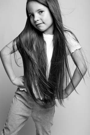 Beautiful child. Little girl in black and white studio. High quality photo.の写真素材
